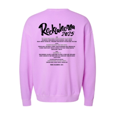 Light pink/lavender crewneck sweatshirt with a large skull graphic surrounded by blooming purple flowers and green leaves. Text reads “Rocklahoma 2025” in dark green lettering.